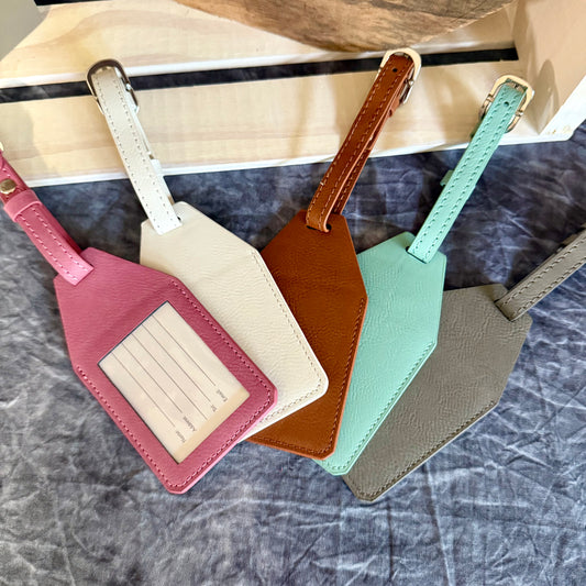 Leatherette luggage tag blanks in white, gray, teal, rawhide, pink, and black.